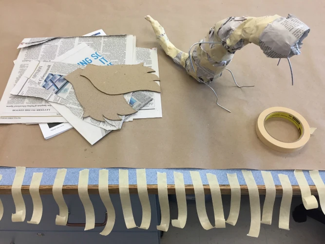 The second step of creating a dragon with Rigid Wrap plaster cloth is to form the body.